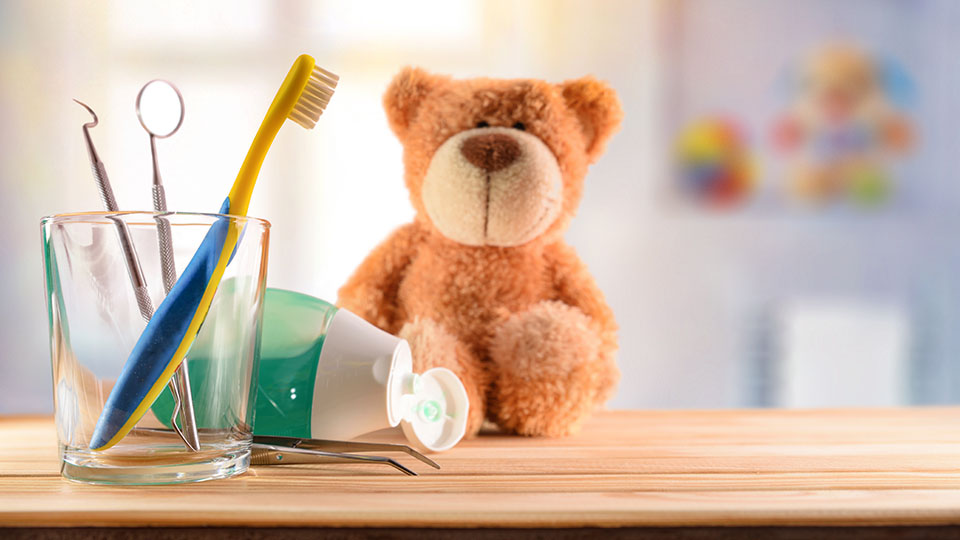 Dentist concept for children with tools in glass cup